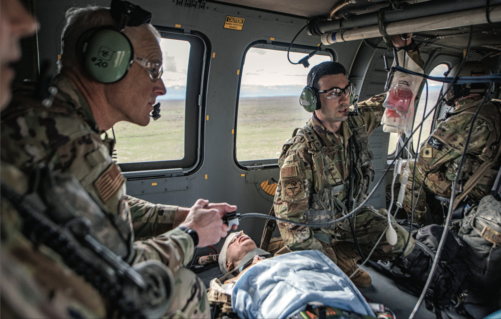 Airmen from Idaho National Guard’s 124th Medical Group Critical Care Air Transport Team work with pilots and medevac Soldiers from 1st of168th Aviation Regiment to stabilize casualties onboard UH-60 Black Hawk helicopter, February 2, 2024, near Gowen Field, Boise, Idaho (U.S. AirNational Guard/Becky Vanshur)